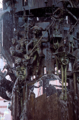 Close-up of the Tower of Fools sculpture with its jesters and fools diving from on high into the water.