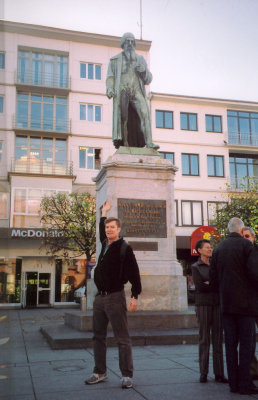 Me pointing to the statue of Gutenberg, the inventor of the printing press, on Gutenbergplatz near the cathedral.