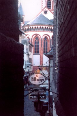 A view of a church (in the Rhine town) through a narrow alleyway.