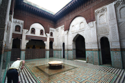 After a downpour in Meknčs, this man was mopping up water in Medrassa Bou Inania completed in 1358 (a medrassa is a school).