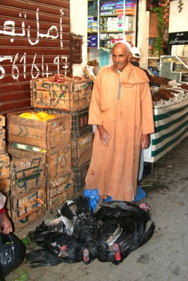 As I walked through the souk, I spotted this man who was selling live chickens.