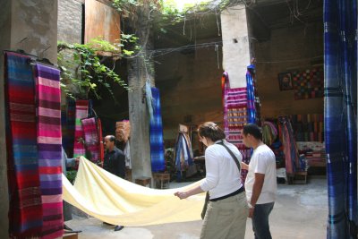 Tourists examining fabrics in the weaving factory in Fs.