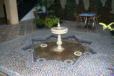 Fountain with beautiful mosaics inside the Hotel Batha.