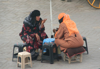 Two mysterious-looking women were engrossed in conversation.