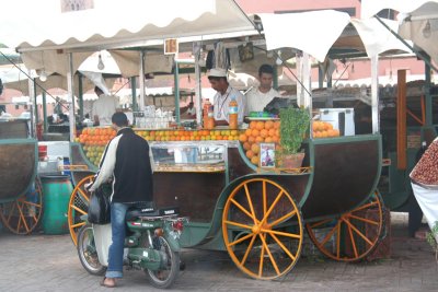 Close-up of an orange juice cart.