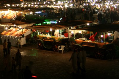 Close-up of the orange juice stands at night.