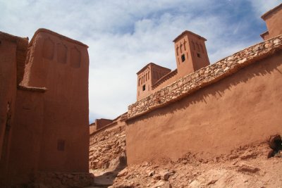 The red earthen walls and buildings are typical of the architecture of southern Morocco.