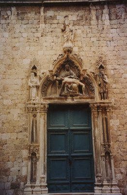 Brothers Petrovic, the portal of the 15th century Franciscan Church with a Madonna and Child carving.