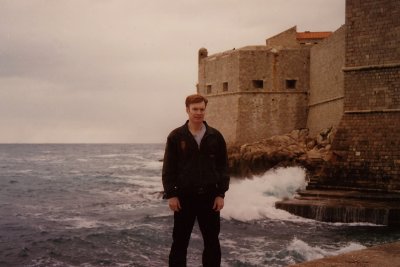 Me standing in front of Dubrovnik's rampart walls with waves of the Adriatic Sea crashing behind me.