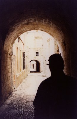 A silhouette shot in front of some of Dubrovnik's arched passageways.
