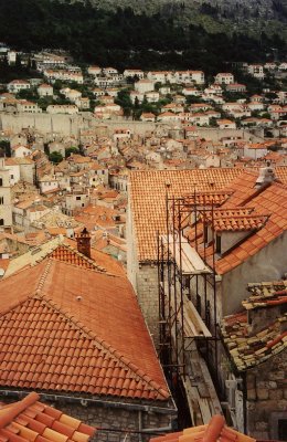 Red terra cotta rooftops seen along the top of the southern defense wall of Dubrovnik.