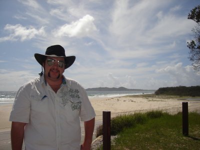 Matthew at the beach with lighthouse in background.JPG