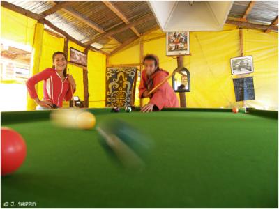 Tourists playing pool in the Guest House