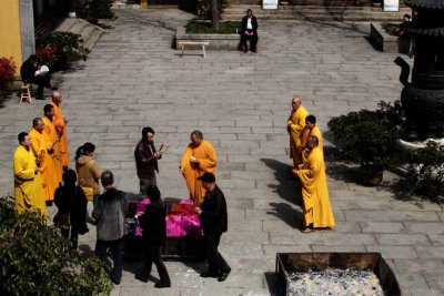 Family circles the gifts three times while monks chant and play instruments
