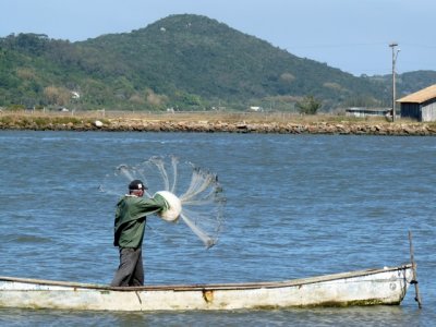 A fisherman casts his net