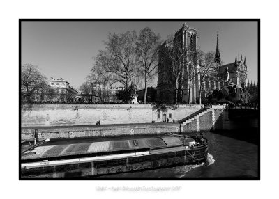 Barge passing along Notre Dame