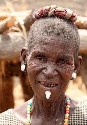 Tamberma woman with a white stone pierced through a hole under her lip.
