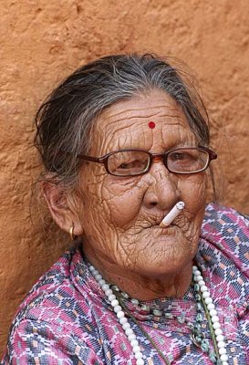 Lady smoking a cigarette, Nepal.