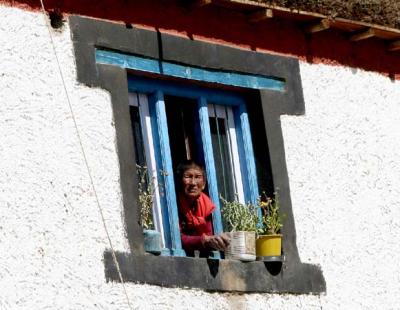 Nun in a window in Kungri Spiti