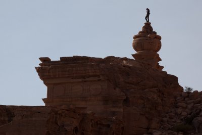 Local man perched on top of the Monastery, seen from behind.