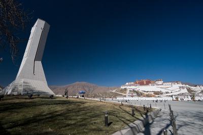 The Monument to the Peaceful Liberation of Tibet on the left, across the square from Potala Palace.
