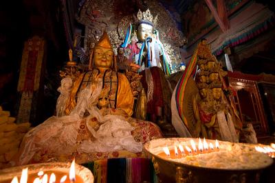 Various images of Buddha and Bodhisattvas with Yak butter offerings in front.