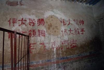 Once a portrait of Mao, audaciously placed within the monastery, now has clearly been angrily scratched off the wall.