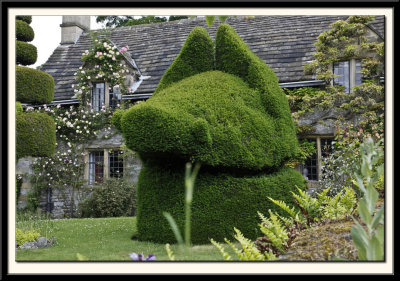 Cottage with Topiary and Flowers