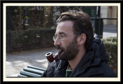 A pipe-smoker by the canal