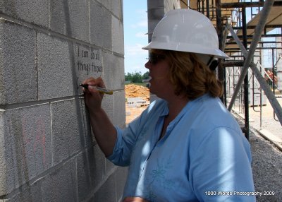 Mrs. Dawson writes on the third grade classroom wall