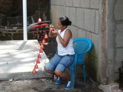 artisan painting a wind chime