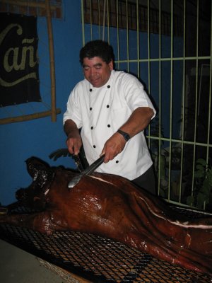 Pedro carving the pig
