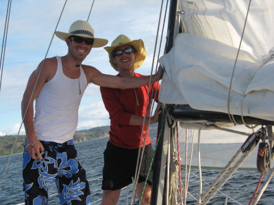 Two guys holding up the sail