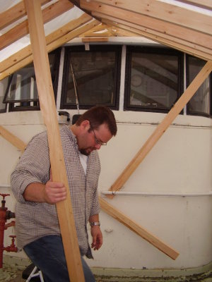 Micah makes a slight and important adjustment to one of the buildings structural support beams.