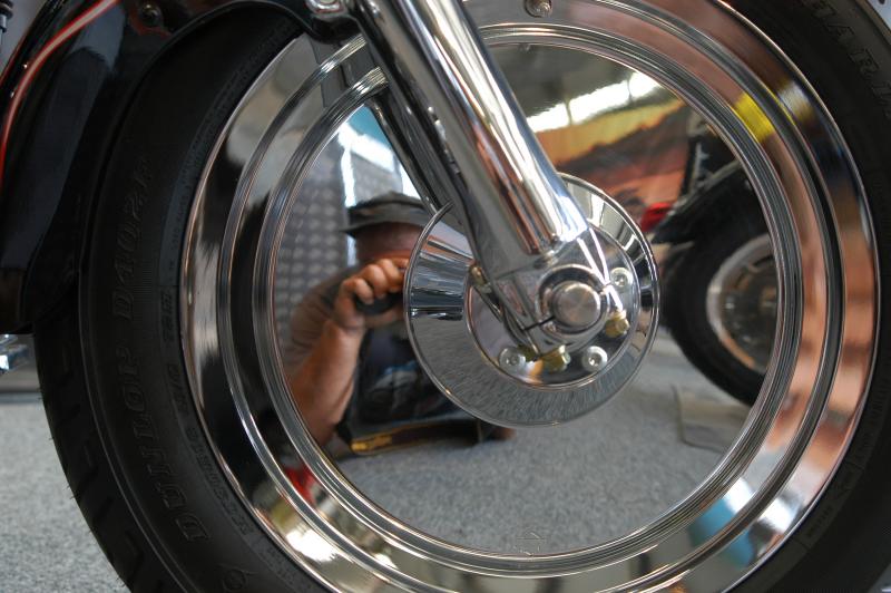 ATTEMPT AT A SELF PORTRAIT IN A HARLEY-DAVIDSON WHEEL.
