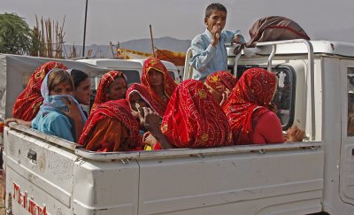 Ten Women and Boy in Pickup