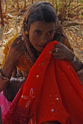 Mother Sewing and Nursing