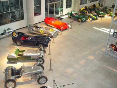 THE BASEMENT RESTORATION AREA HAD A LOT OF VEHICLE BEING WORKED ON, ALSO BEHIND THE GLASS
