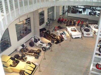 LOOK CLOSE AND YOU CAN SEE MORE MOTORCYCLES BEING RESTORED BEHIND THE GLASS IN THE BACKGROUND