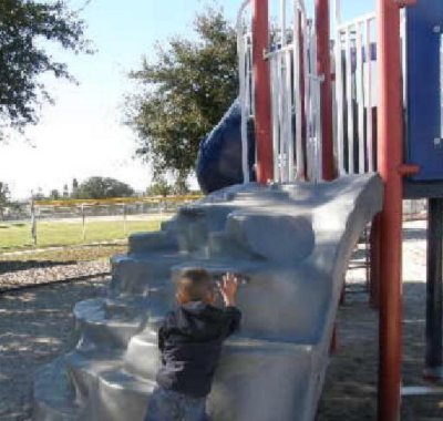 Christopher on the rock wall.JPG