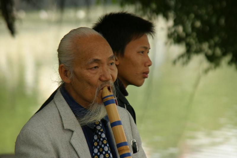 Musician at Hoan Kiem Lake, with audience