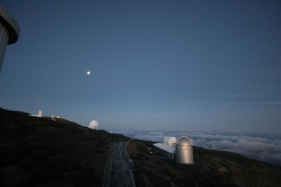 20D 180 - The first rays of sunlight strike the domes of theRoque de los Muchachos Observatory
