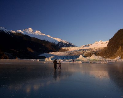 Mendenhall Lake is frozen solid now and these people are skating on the frozen surface