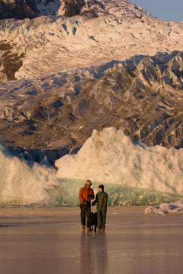 Locals on the frozen surface of Mendenhall Lake with the Mendenall Glacier towering over them