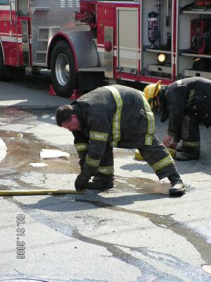 Fall River Firefighter rolling hose