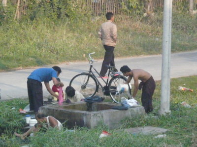 public well where people bathe & wash their clothes