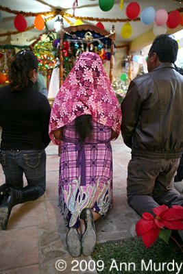 Praying at Posada Altar