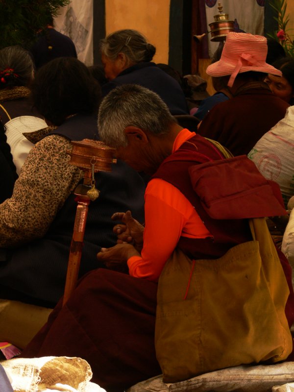 Leaning on prayer wheel