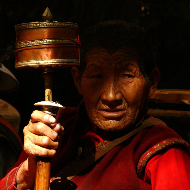 Holding prayer wheel