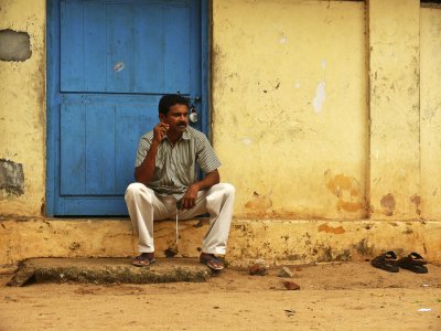Man against blue door Trivandrum.jpg